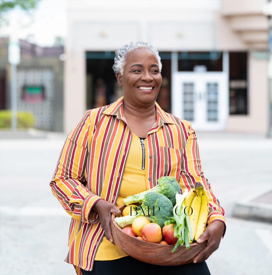Pauline carrying a basket of fresh produce